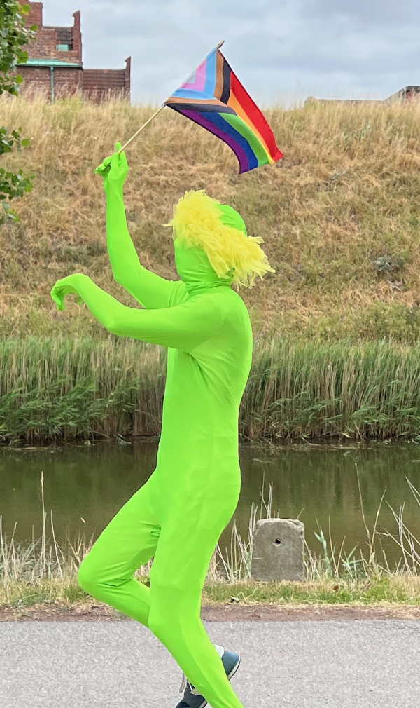 Happy green man with Pride flag.
